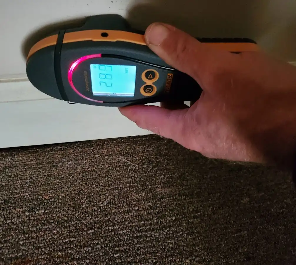 Moisture detection at baseboard during Storm Damage Restoration in Armada